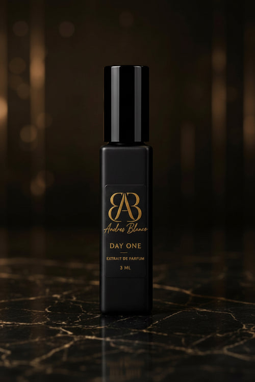 Andres Blanco Day One perfume bottle with gold logo on a dark background